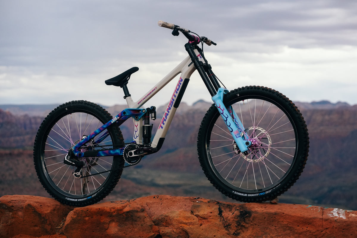 Hannah Bergemann's hand-painted Transition Bottlerocket on a red rock ledge above the canyon.