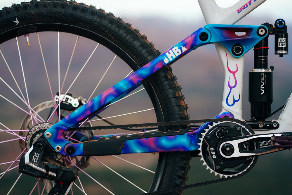 HB lettering in the blue and pink swirl paint on the swingarm.