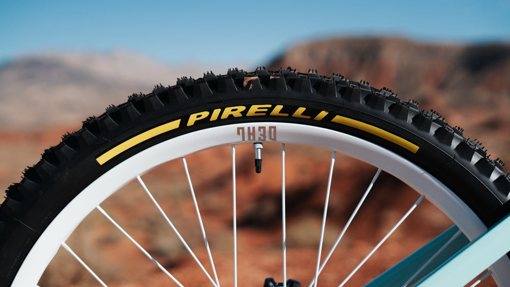 Pirelli tire with yellow lettering on a white rim.