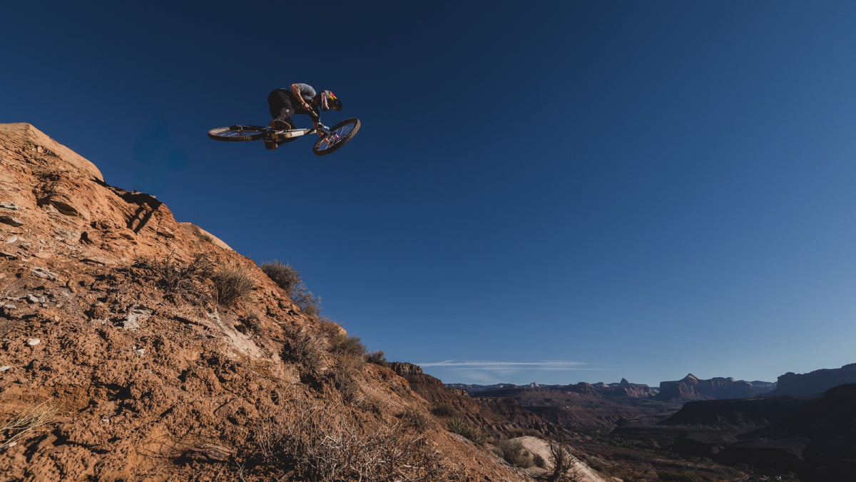 A rider airs a step-down above the valley. Photo: Robin O'Neill.