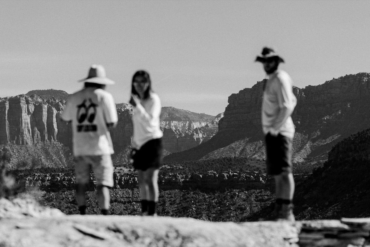 Three people look out over the canyon in black and white. Photo: Robin O'Neill.