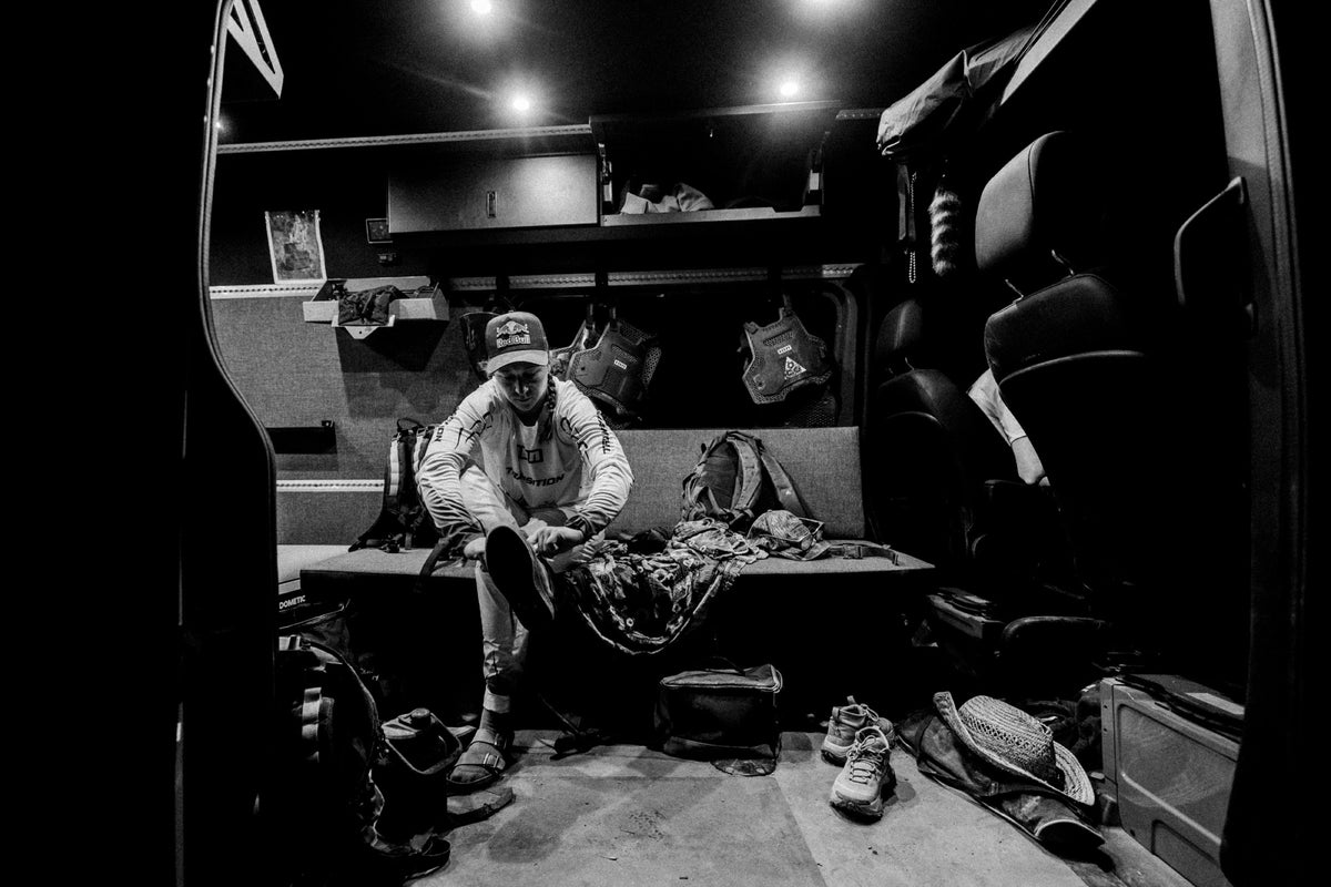 Hannah's crew rests in a van at night in black and white. Photo: Robin O'Neill.
