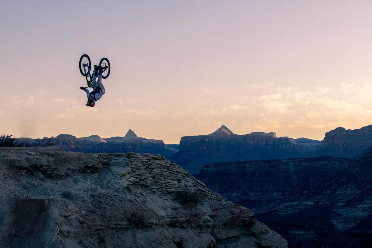A rider backflips above the canyon rim at sunset. Photo: Robin O'Neill.