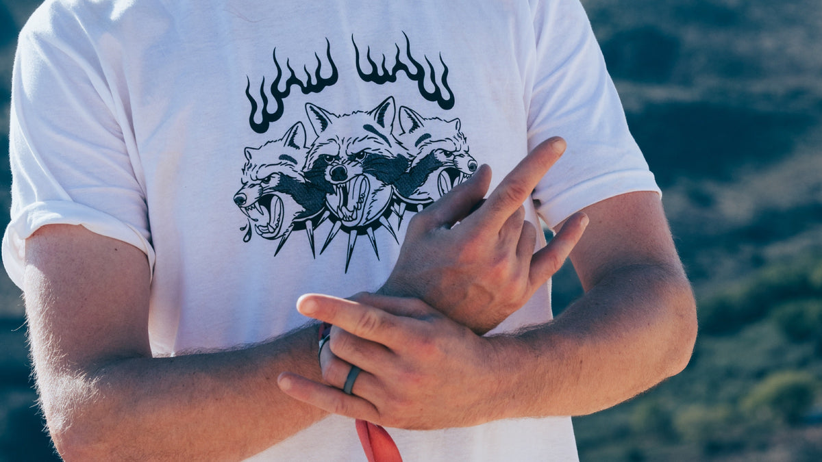 A crew member in a flame graphic T-shirt with arms crossed. Photo: Robin O'Neill.