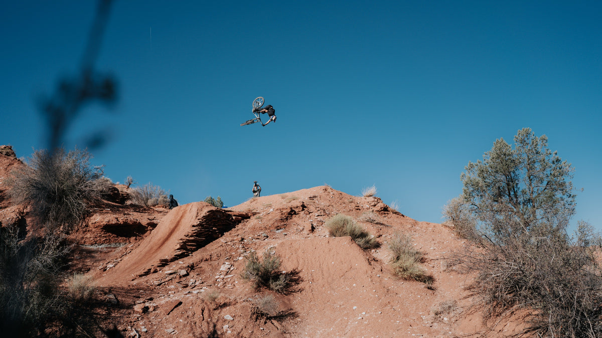 Johny Salido flies over a sagebrush hillside.