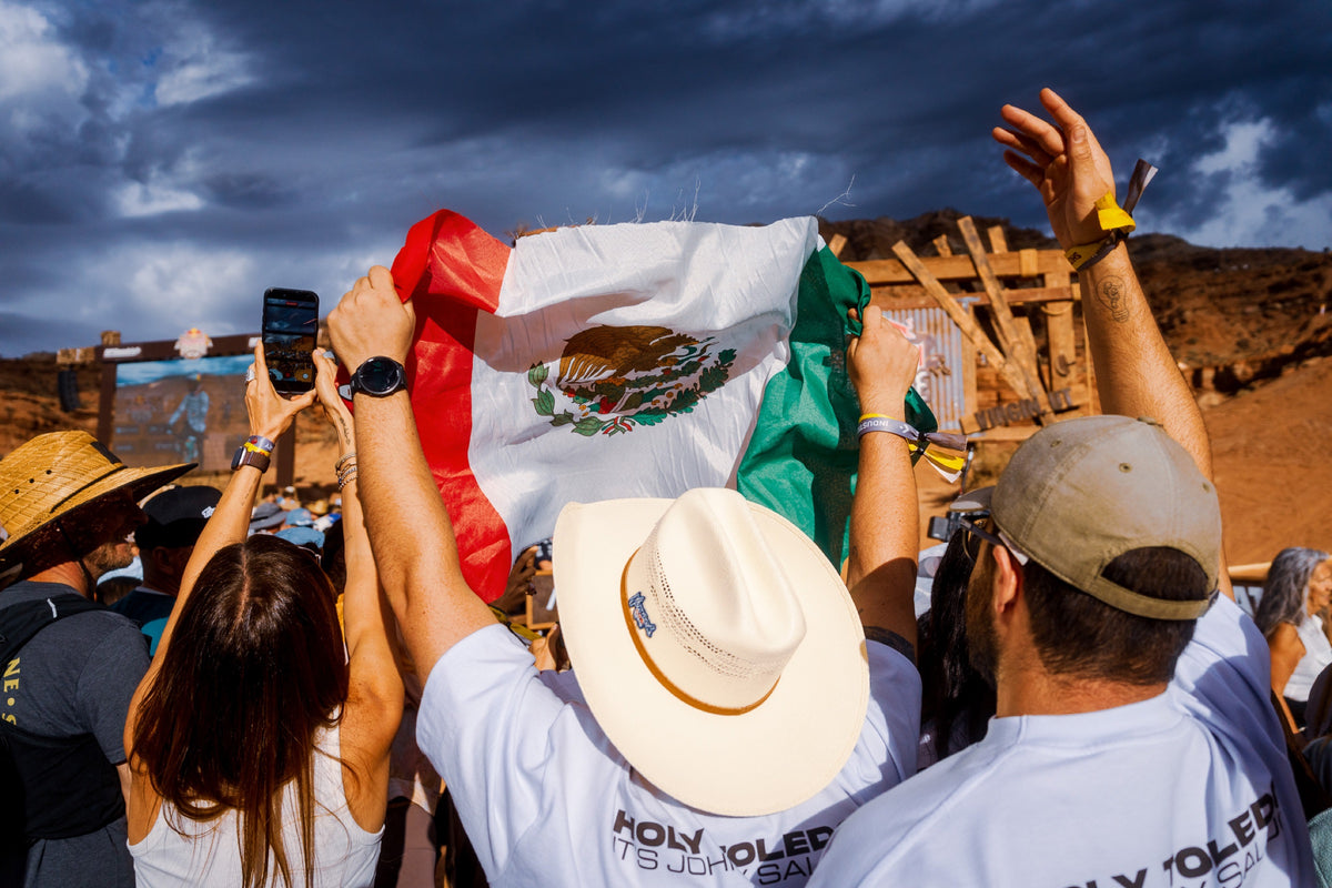 Fans wave Mexican flags as Johny comes down.